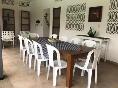 a dining room with a table and white chairs at CASAQUINTA PRIVADA MARIQUITA-TOLIMA in Mariquita