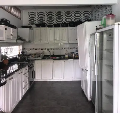 a white kitchen with white cabinets and a refrigerator at CASAQUINTA PRIVADA MARIQUITA-TOLIMA in Mariquita
