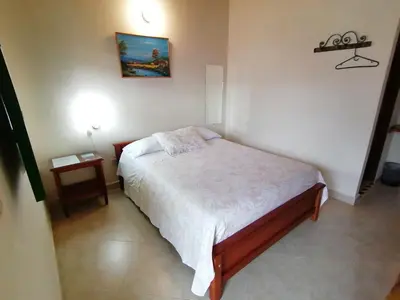 a small bedroom with a bed and a table at Balcones del Parque Jardin in Jardin