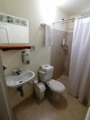 a bathroom with a toilet and a sink and a shower at Balcones del Parque Jardin in Jardin