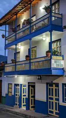 a hotel with blue balconies on a building at Hotel Dorado Jardín in Jardin