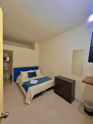 a bedroom with a bed and a dresser in it at Hotel Dorado Jardín in Jardin