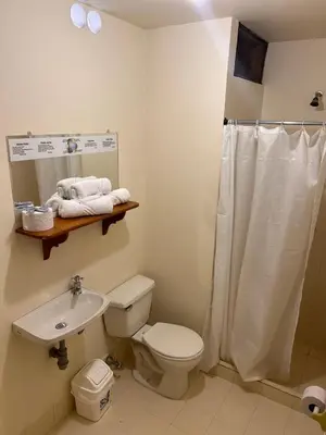 a bathroom with a white toilet and a sink at Hotel Dorado Jardín in Jardin