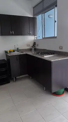 a kitchen with black cabinets and a counter top at Apartamento 2 habitaciones aire acondicionado en Sopetran Unidad res Piscinas sol y descanso in Sopetran