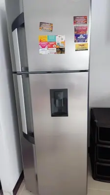 a white refrigerator with magnets and papers on it at Apartamento 2 habitaciones aire acondicionado en Sopetran Unidad res Piscinas sol y descanso in Sopetran