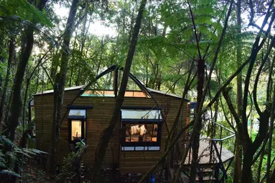 a tiny house in the woods with trees at Chalet Tanat in Santa Elena