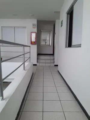 a hallway of a building with stairs and a door at Hotel Palermo Real in Medellín