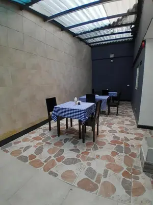 a dining room with tables and chairs and a skylight at Hotel Palermo Real in Medellín