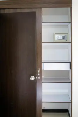 a closet with a wooden door with a clock on it at Super Apartment El Poblado Tesoro 2 rooms, 3 baths - 6 guests in Medellín