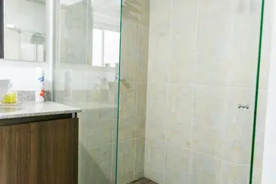 a shower with a glass door in a bathroom at Super Apartment El Poblado Tesoro 2 rooms, 3 baths - 6 guests in Medellín
