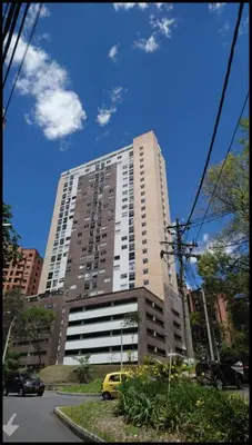 a tall building with a yellow van in front of it at Super Apartment El Poblado Tesoro 2 rooms, 3 baths - 6 guests in Medellín
