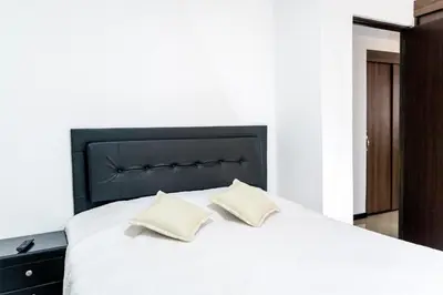 a bedroom with a large white bed with two pillows at Super Apartment El Poblado Tesoro 2 rooms, 3 baths - 6 guests in Medellín