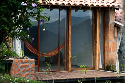 a window on a house with a view of the mountains at Aldea Sabatinga in Manizales