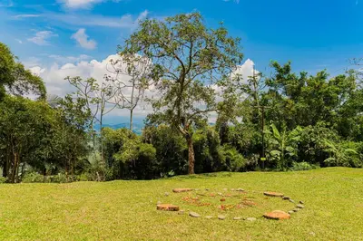 a pile of rocks in the grass in a field at Aldea Sabatinga in Manizales