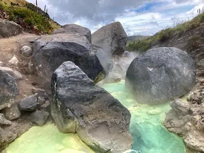 a river with large rocks in the water at Aldea Sabatinga in Manizales