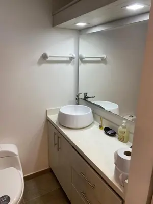 a bathroom with a sink and a toilet and a mirror at 712 Apartasuite moderna - en el corazón del poblado medellín in Medellín