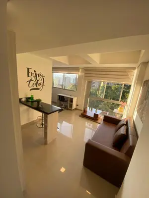 a living room with a couch and a table at 712 Apartasuite moderna - en el corazón del poblado medellín in Medellín