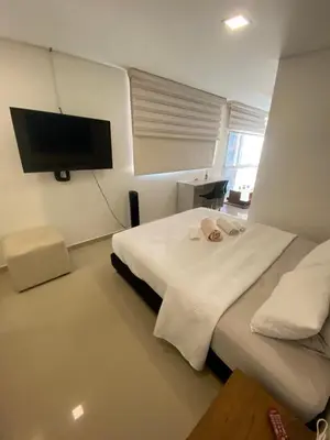 a room with two beds and a flat screen tv at 712 Apartasuite moderna - en el corazón del poblado medellín in Medellín