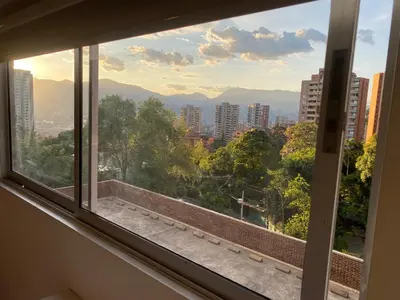 a window with a view of a city at 712 Apartasuite moderna - en el corazón del poblado medellín in Medellín