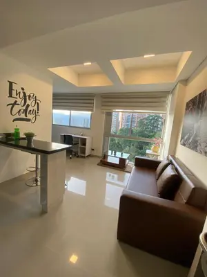 a living room with a couch and a table at 712 Apartasuite moderna - en el corazón del poblado medellín in Medellín