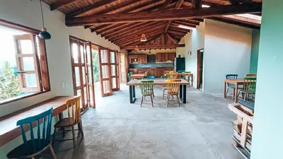 a kitchen with wooden ceilings and tables and chairs at Glamping Jardín in Jardin