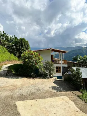 a house with a balcony on the side of it at Glamping Jardín in Jardin