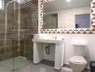 a bathroom with a toilet and a sink and a shower at El Oscar Hotel in Medellín