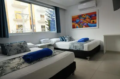 a room with two beds and a basketball hoop at El Oscar Hotel in Medellín