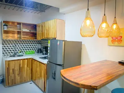 a kitchen with a wooden table and a refrigerator at Glen Apt de 2 alcobas Mejor zona medellin in Medellín
