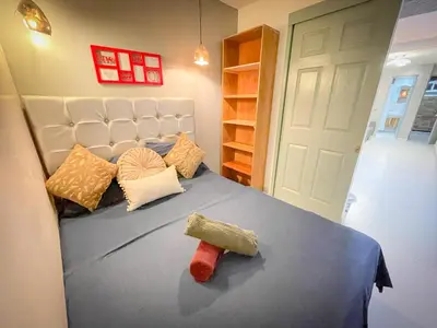 a bedroom with a bed with pillows on it at Glen Apt de 2 alcobas Mejor zona medellin in Medellín