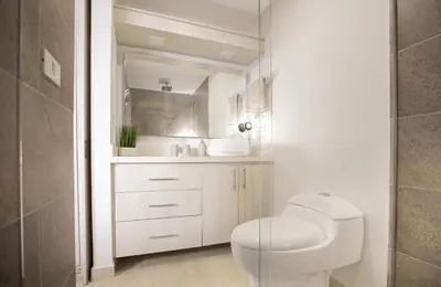 a bathroom with a toilet and a sink at Elegante Apto en el Poblado! Vista Fabulosa in Medellín