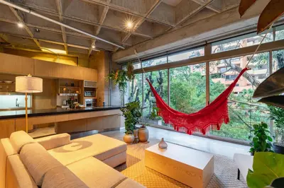 a living room with a couch and a large window at Soho Lofts by Vibra Bonita in Medellín