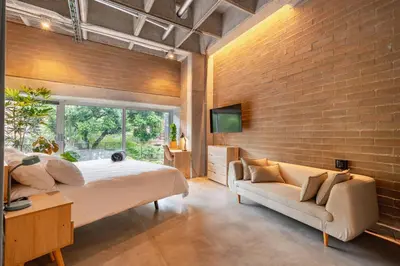 a bedroom with a large bed and a couch at Soho Lofts by Vibra Bonita in Medellín