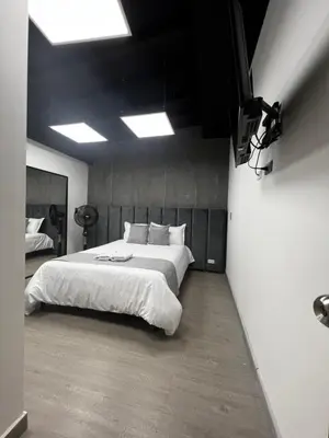 a bedroom with a large white bed in a room at Orbe Hotel Medellín in Medellín