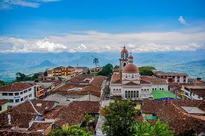 a view of a town with a clock tower and roofs at Petroglifo Room Támesis in Támesis
