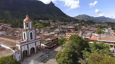 a view of a town with a clock tower at Petroglifo Room Támesis in Támesis