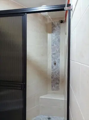 a walk in shower with a glass shower door at Petroglifo Room Támesis in Támesis