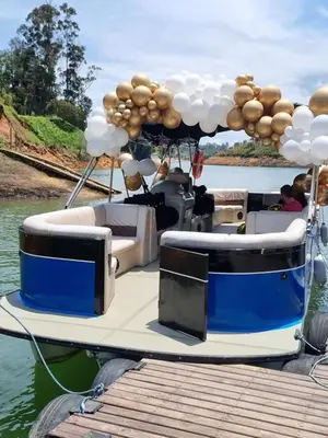 a boat tied up to a dock with balloons on it at Hotel Casa Linda Guatape in Guatapé