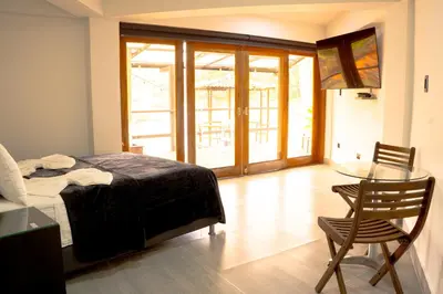 a bedroom with a bed and a glass table at Hotel Casa Linda Guatape in Guatapé