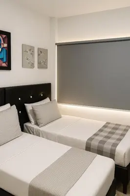 two beds in a hotel room with two beds at Apto 201 Sweet Home Medellín in Medellín