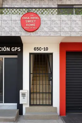 a building with two doors and a red sign on it at Apto 201 Sweet Home Medellín in Medellín