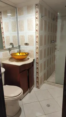 a bathroom with a sink and a toilet and a shower at Habitación central con cama doble #2 in Medellín