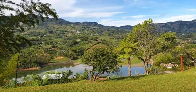 a view of a river with mountains in the background at Finca Buena Vista in Guatapé