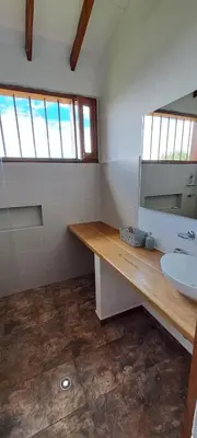 a bathroom with a sink and a mirror at Finca Buena Vista in Guatapé
