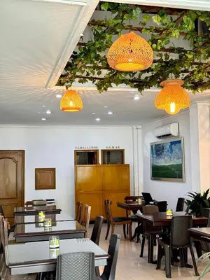 a dining room with tables and chairs and lights at Hotel Prince Plaza - Laureles Estadio in Medellín