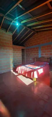 a room with a bed in a brick wall at Casa Hotel los Patios in Jericó