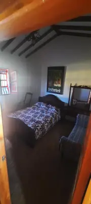 a bedroom with a bed and a couch at Casa Hotel los Patios in Jericó