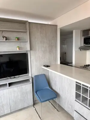 a kitchen with a blue chair and a counter at 2511 Suite Moderna y de lujo con la mejor vista a la ciudad - Poblado Medellín in Medellín