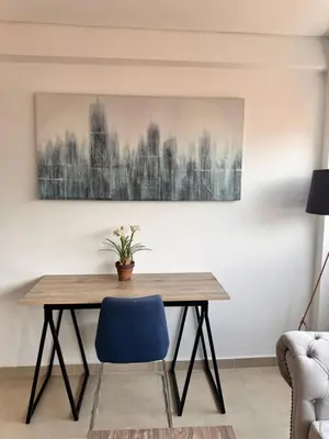 a dining room with a wooden table and a blue chair at 2511 Suite Moderna y de lujo con la mejor vista a la ciudad - Poblado Medellín in Medellín