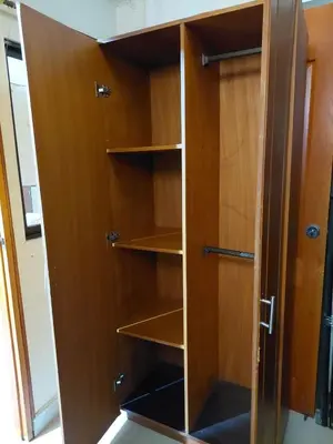 a wooden cabinet with empty shelves in a room at Cápsula Urbana Central #4 in Medellín